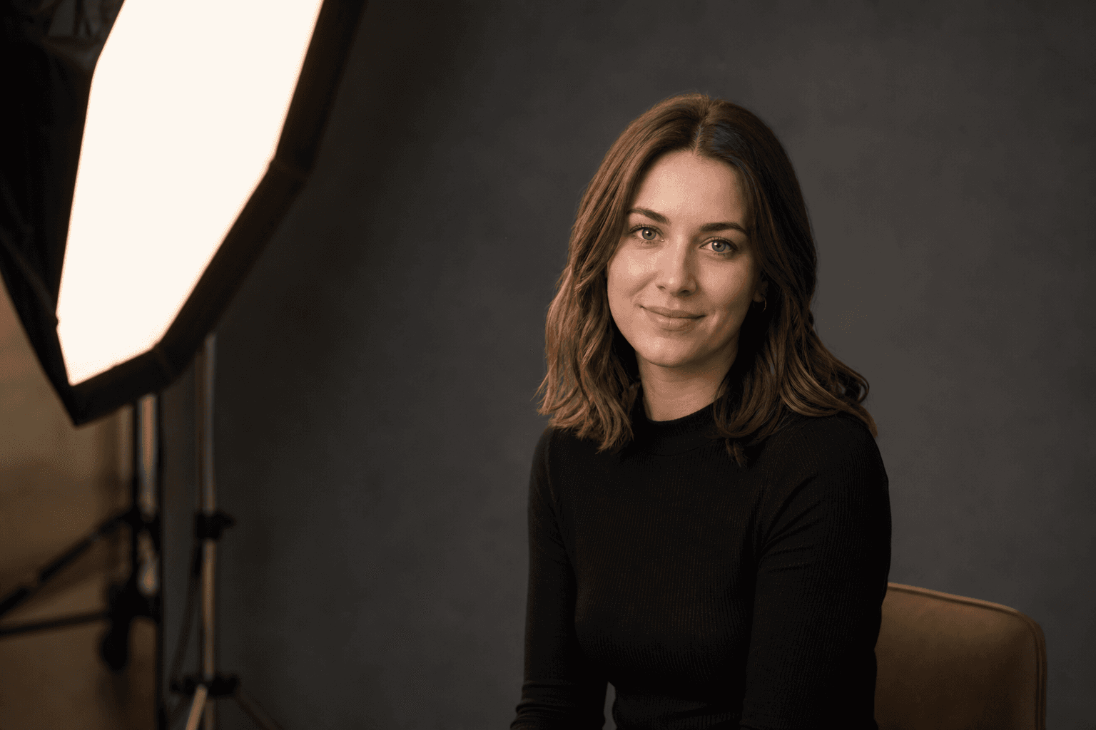 Studio portrait lighting — softbox key light and model in a home studio